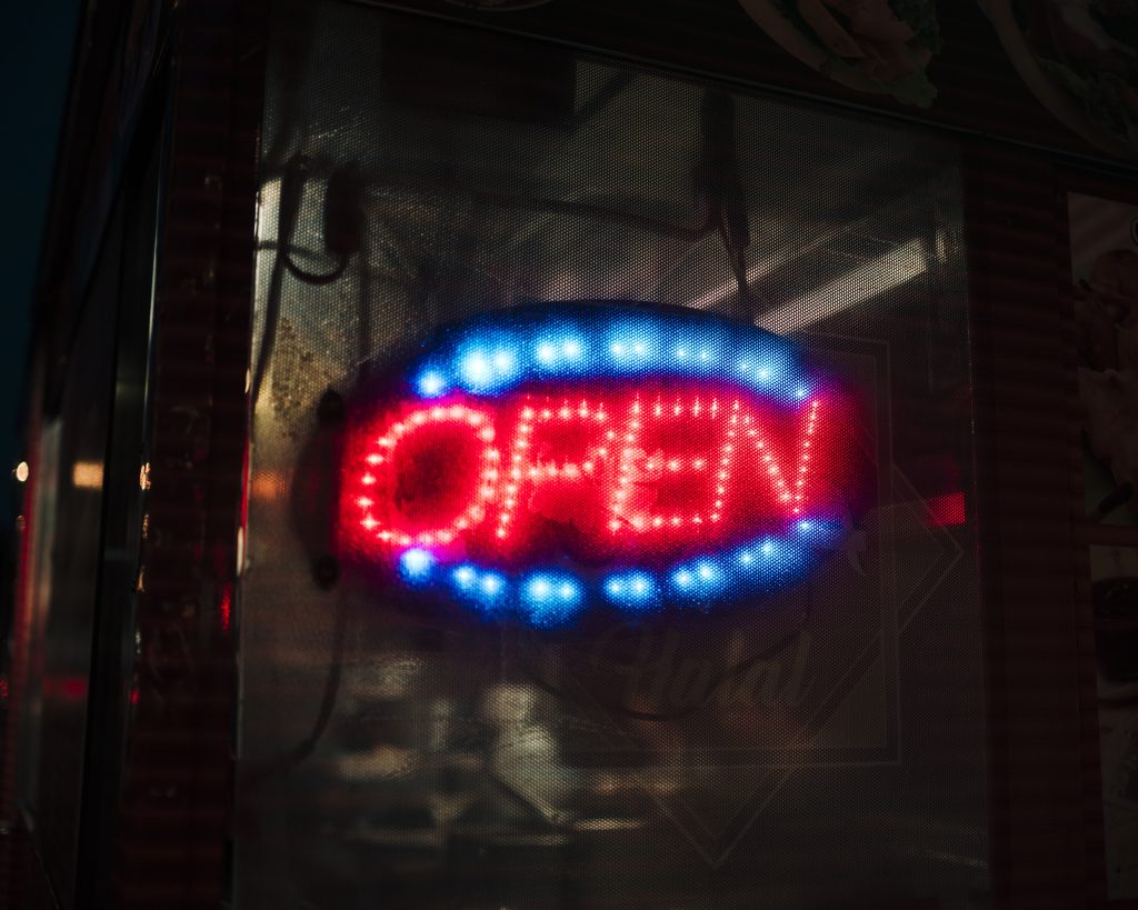 blurred open sign neon lights